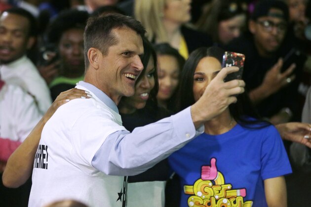 Michigan football coach Jim Harbaugh takes a selfie with first lady Michelle Obama, center, and Grammy award winner Ciara during the citywide College Signing Day, Friday, May 1, 2015, at Wayne State University in Detroit. The first lady talked to a rally of more than 2,000 Detroit high school students about the importance of committing to education beyond high school as part of her