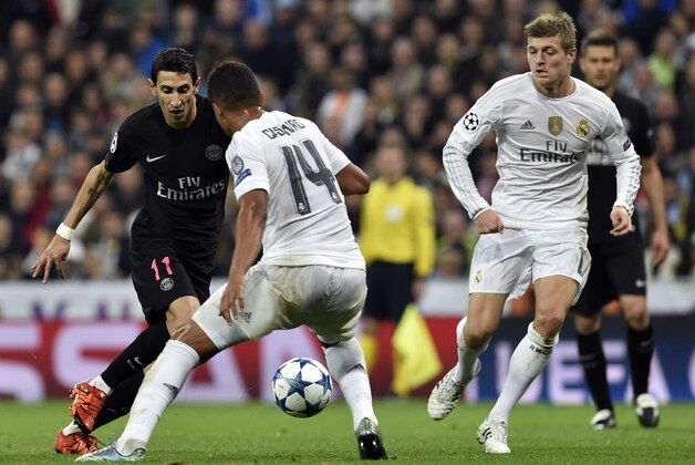Paris Saint-Germain's Argentinian forward Angel Di Maria (L) vies with Real Madrid's Brazilian midfielder Casimiro (C) and Real Madrid's German midfielder Toni Kroos (R) during the UEFA Champions League group stage football match Real Madrid CF vs Paris Saint-Germain (PSG) at the Santiago Bernabeu stadium in Madrid on November 3, 2015.   AFP PHOTO / GERARD JULIEN        (Photo credit should read GERARD JULIEN/AFP/Getty Images)