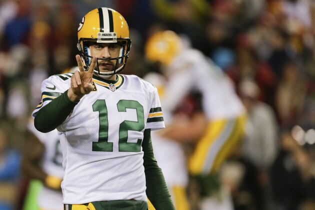 Green Bay Packers quarterback Aaron Rodgers (12) signals after  running back James Starks (44) scores a touchdown during the second half of an NFL wild card playoff football game against the Washington Redskins in Landover, Md., Sunday, Jan. 10, 2016. (AP Photo/Mark Tenally)