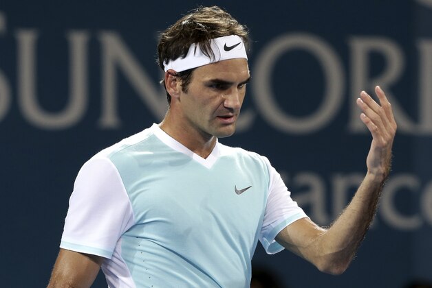 Roger Federer of Switzerland reacts after missing a shot in the men's final match against Milos Raonic of Canada during the Brisbane International tennis tournament in Brisbane, Australia, Sunday, Jan. 10, 2016. (AP Photo/Tertius Pickard)