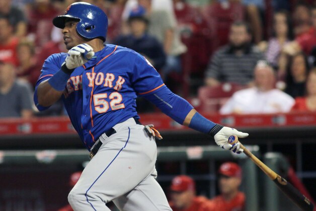 New York Mets Yoenis Cespedes hits an RBI single against the Cincinnati Reds in the seventh inning of a baseball game in Cincinnati, Thursday, Sept. 24, 2015. (AP Photo/Tom Uhlman)