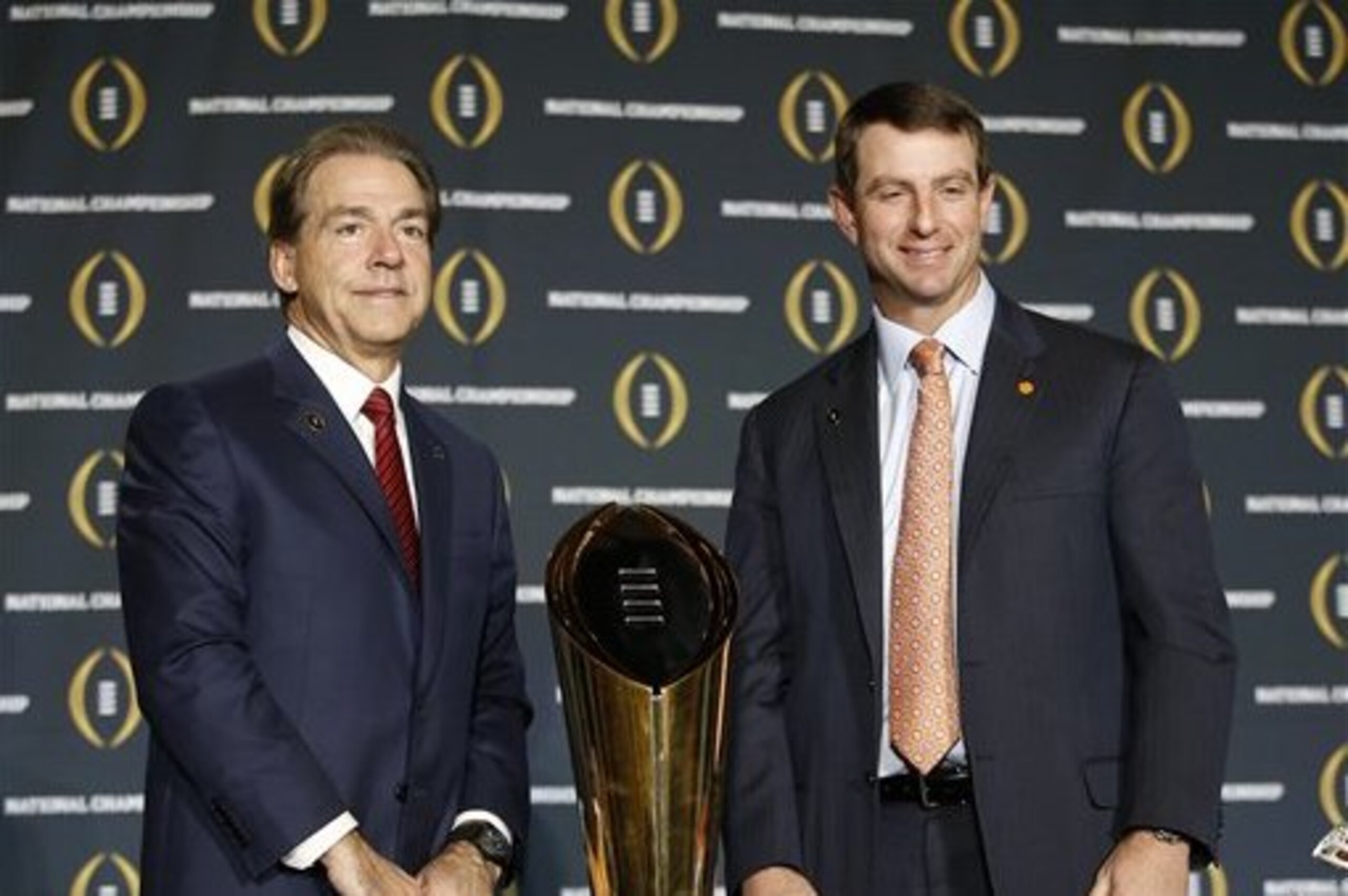 Clemson head coach Dabo Swinney and Alabama head coach Nick Saban pose for a picture during a news conference for the NCAA college football playoff championship game Sunday, Jan. 10, 2016, in Glendale, Ariz. (AP Photo/Morry Gash)