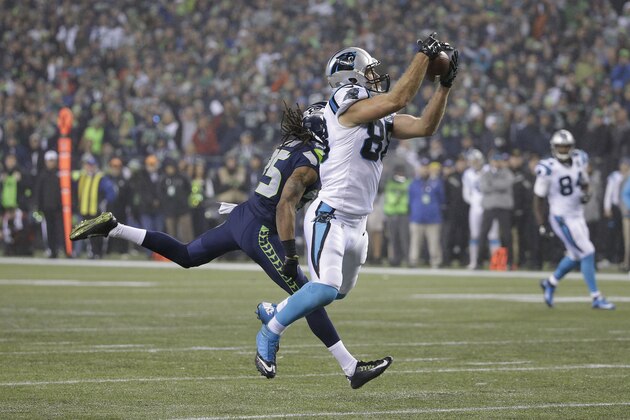 Carolina Panthers tight end Greg Olsen (88) catches a pass in front of Seattle Seahawks cornerback Richard Sherman (25) during the second half of an NFL divisional playoff football game in Seattle, Saturday, Jan. 10, 2015. (AP Photo/Elaine Thompson)