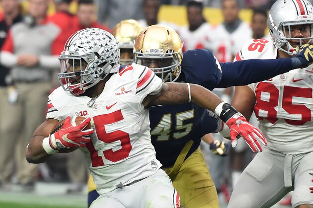 GLENDALE, AZ - JANUARY 01:  Ezekiel Elliott #15 of the Ohio State Buckeyes runs with the ball as Romeo Okwara #45 of the Notre Dame Fighting Irish attempts to make a tackle during the BattleFrog Fiesta Bowl at the University of Phoenix Stadium on January 1, 2016 in Glendale, Arizona. Buckeyes won 44-28.  (Photo by Norm Hall/Getty Images)