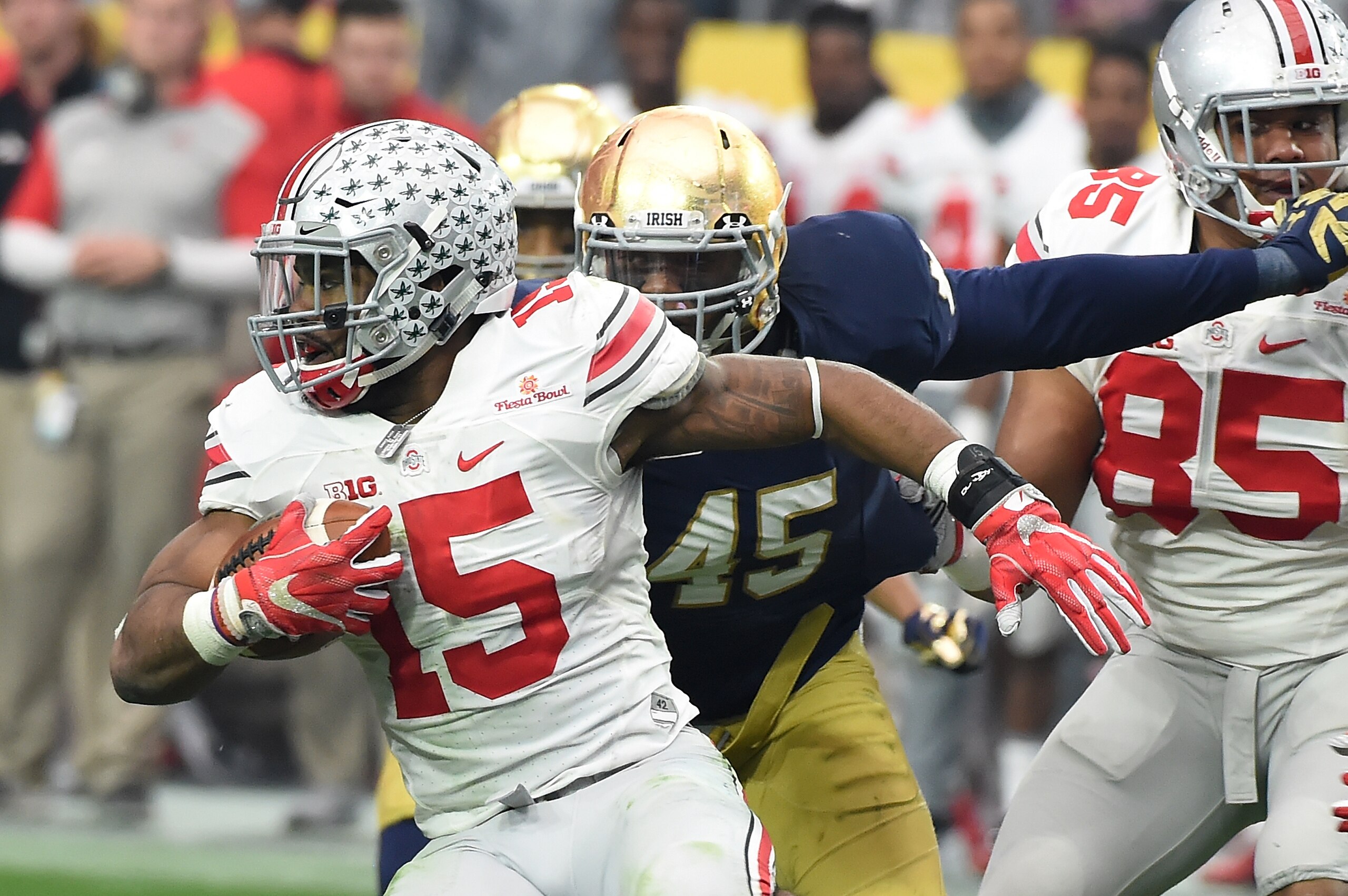GLENDALE, AZ - JANUARY 01:  Ezekiel Elliott #15 of the Ohio State Buckeyes runs with the ball as Romeo Okwara #45 of the Notre Dame Fighting Irish attempts to make a tackle during the BattleFrog Fiesta Bowl at the University of Phoenix Stadium on January 1, 2016 in Glendale, Arizona. Buckeyes won 44-28.  (Photo by Norm Hall/Getty Images)
