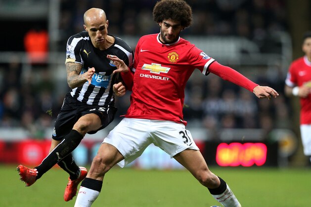 Manchester United's Marouane Fellaini, right, vies for the ball with Newcastle United's Gabriel Obertan, left, during their English Premier League soccer match between Newcastle United and Manchester United at St James' Park, Newcastle, England, Wednesday, March, 4, 2015. (AP Photo/Scott Heppell)