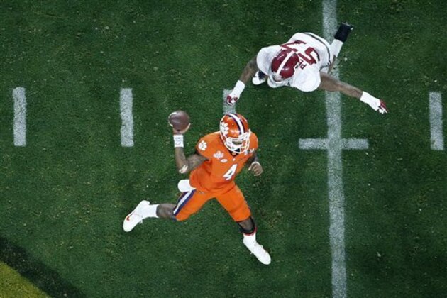 Clemson's Deshaun Watson (4) throws while being rushed by Alabama's D.J. Pettway (57) during the second half of the NCAA college football playoff championship game Monday, Jan. 11, 2016, in Glendale, Ariz. (AP Photo/Ross D. Franklin)