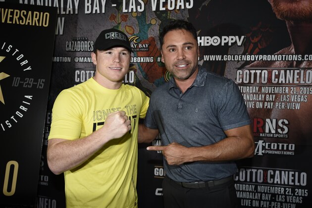 SAN DIEGO, CA - OCTOBER 29:   Canelo Alvarez, former WBC and WBA Super Welterweight World Champion, left, poses for photos with Oscar De La Hoya during a media workout at the House of Boxing Gym October 29, 2015 in San Diego, California.  (Photo by Denis Poroy/Getty Images)