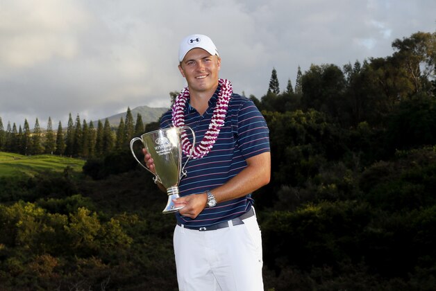 Jordan Spieth holds the champions trophy after the final round of the Tournament of Champions golf tournament, Sunday, Jan. 10, 2016, at Kapalua Plantation Course on Kapalua, Hawaii. Spieth finished at 30 under par for the tournament win. (AP Photo/Matt York)