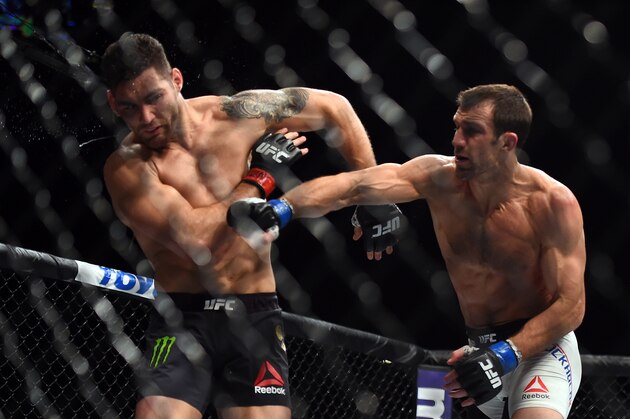 LAS VEGAS, NEVADA - DECEMBER 12:  (R-L) Luke Rockhold punches Chris Weidman in their middleweight championship bout during the UFC 194 event inside MGM Grand Garden Arena on December 12, 2015 in Las Vegas, Nevada.  (Photo by Jeff Bottari/Zuffa LLC/Zuffa LLC via Getty Images)