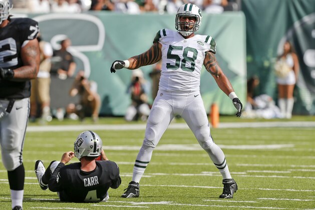 New York Jets defensive end Jason Babin (58) celebrates after sacking Oakland Raiders quarterback Derek Carr (4) during the second half of an NFL football game Sunday, Sept. 7, 2014, in East Rutherford, N.J. (AP Photo/Seth Wenig)