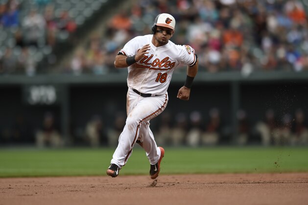 Baltimore Orioles' Gerardo Parra races to third base against the New York Yankees in a baseball game in Baltimore, Sunday, Oct. 4, 2015. (AP Photo/Gail Burton)