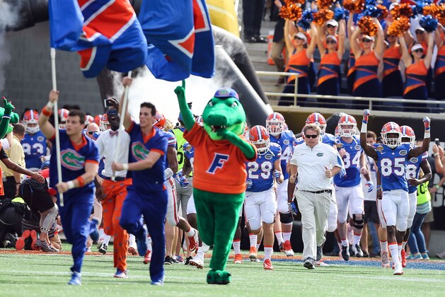 Jan 1, 2016; Orlando, FL, USA; Florida Gators head coach Jim McElwain and his team take the field before the 2016 Citrus Bowl against the Michigan Wolverines at Orlando Citrus Bowl Stadium. Mandatory Credit: Jim Dedmon-USA TODAY Sports