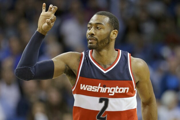 Washington Wizards' John Wall (2) waves there fingers after sinking a 3-point shot against the Orlando Magic during the second half of an NBA basketball game, Saturday, Jan. 9, 2016, in Orlando, Fla.  Washington won 105-99. (AP Photo/John Raoux)