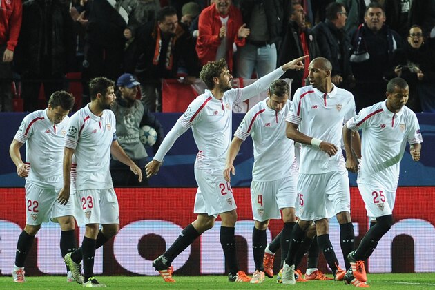 Sevilla's Spanish forward Fernando Llorente (C) celebrates with teammates after scoring a goal during the UEFA Champions League Group D football match Sevilla FC vs Juventus at the Ramon Sanchez Pizjuan stadium in Sevilla on December 8, 2015.   AFP PHOTO/ CRISTINA QUICLER / AFP / CRISTINA QUICLER        (Photo credit should read CRISTINA QUICLER/AFP/Getty Images)