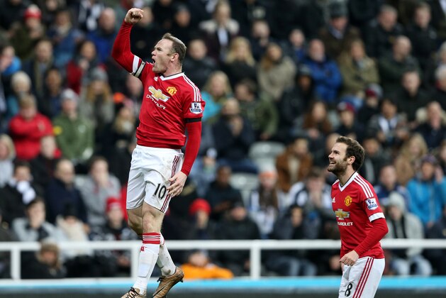 Manchester United's Wayne Rooney, left, celebrates his goal during the English Premier League soccer match between Newcastle United and Manchester United at St James' Park, Newcastle, England, Tuesday, Jan. 12, 2015. (AP Photo/Scott Heppell)