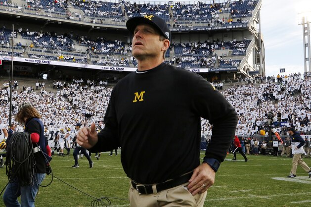 Michigan head coach Jim Harbaugh runs onto the field at the end of an NCAA college football game against Penn State in State College, Pa., Saturday, Nov. 21, 2015. Michigan won 28-16. (AP Photo/Gene J. Puskar)