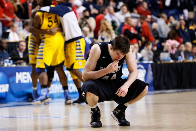 LEXINGTON, KY - MARCH 23:  Andrew Smith #44 of the Butler Bulldogs reacts as the Marquette Golden Eagles celebrate after defeating the Bulldogs during the third round of the 2013 NCAA Men's Basketball Tournament at Rupp Arena on March 23, 2013 in Lexington, Kentucky.  (Photo by Kevin C. Cox/Getty Images)