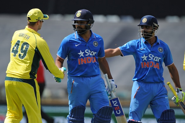 India's Rohit Sharma (2nd L) is congratulated by Australian captain Steve Smith (L) as he leaves the field during the one-day international cricket match between India and Australia in Perth on January 12, 2016.  AFP PHOTO / Greg WOOD
--IMAGE RESTRICTED TO EDITORIAL USE  NO COMMERCIAL USE-- / AFP / GREG WOOD        (Photo credit should read GREG WOOD/AFP/Getty Images)
