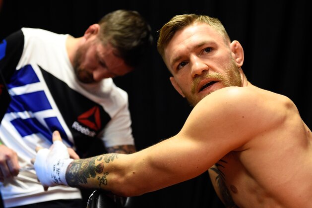 LAS VEGAS, NEVADA - DECEMBER 12:  (R-L) Conor McGregor of Ireland gets his hands wrapped by coach John Kavanaugh backstage during the UFC 194 event inside MGM Grand Garden Arena on December 12, 2015 in Las Vegas, Nevada.  (Photo by Jeff Bottari/Zuffa LLC/Zuffa LLC via Getty Images)