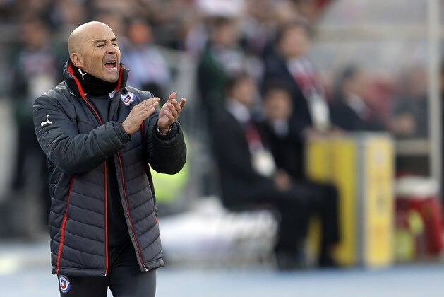 FILE - In this July 4, 2015, file photo, Chile's coach Jorge Sampaoli  shouts instructions from the sideline during the Copa America final soccer match at the National Stadium in Santiago, Chile. Arturo Salah, the new president of Chilean soccer announced Friday, Jan. 8, 2016, that Sampaoli will continue as the head coach of the national team. (AP Photo/Natacha Pisarenko, File)