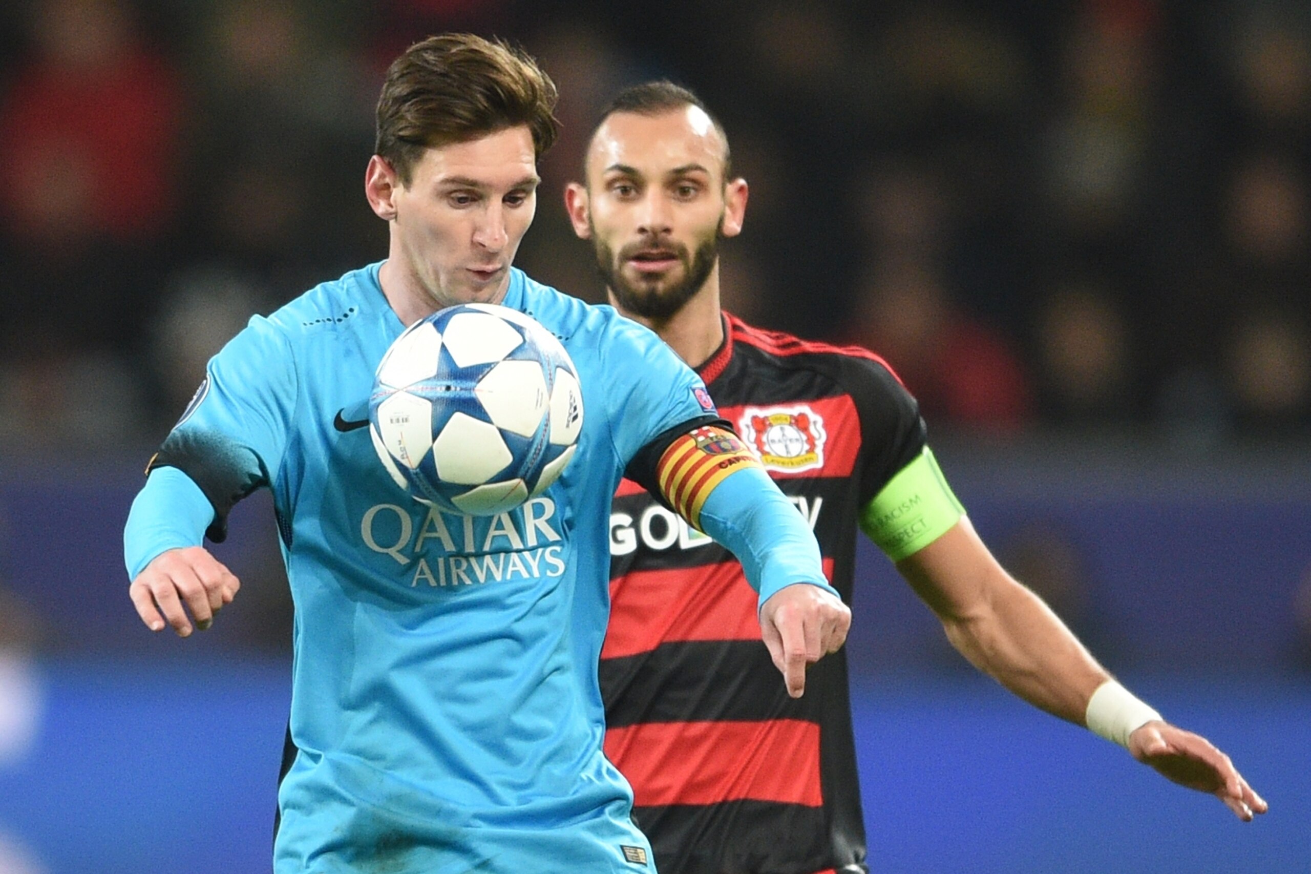 Leverkusen's Omer Toprak, right, and Barcelona's Lionel Messi challenge for the ball during the Champions League Group E soccer match between Bayer Leverkusen and FC Barcelona in Leverkusen, western Germany, Wednesday, Dec. 9, 2015. (AP Photo/Sebastian Konopka)