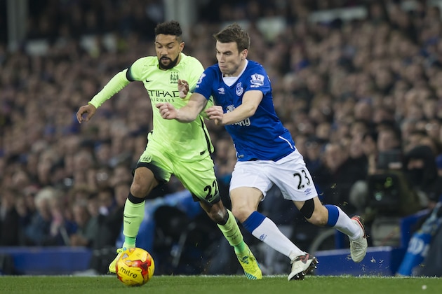 Everton's Seamus Coleman, right, fights for the ball against Manchester City's Gael Clichy during their English League Cup semi final first leg soccer match between Everton and Manchester City at Goodison Park Stadium, Liverpool, England, Wednesday Jan. 6, 2016. (AP Photo/Jon Super)