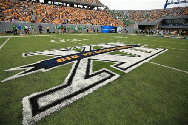 FILE - In this Sept. 1, 2012, file photo, the Big 12 Conference logo is painted on Mountaineer Field for an NCAA college football game between West Virginia and Marshall in Morgantown, W.Va. The Big 12 announced a new 13-year deal with ESPN and Fox Sports on Friday, Sept. 7, 2012, that is reportedly worth $2.6 billion and should provide long-term stability for a conference that once seemed on the brink of collapse.  (AP Photo/Christopher Jackson, File)