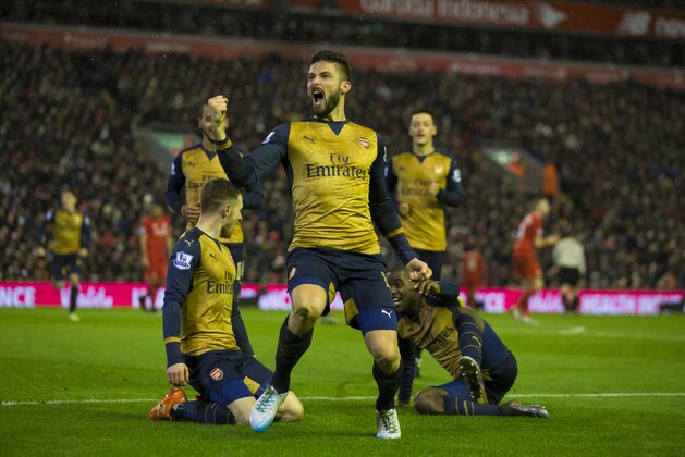 Arsenal's Olivier Giroud, centre, celebrates with teammates after scoring his second goal during the English Premier League soccer match between Liverpool and Arsenal at Anfield Stadium, Liverpool, England, Wednesday, Jan. 13, 2016. (AP Photo/Jon Super)