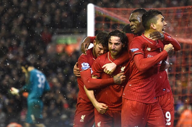 Liverpool's Welsh midfielder Joe Allen (C) celebrates with teammates after scoring during the English Premier League football match between Liverpool and Arsenal at Anfield stadium in Liverpool, north-west England on January 13, 2016.
AFP PHOTO / PAUL ELLIS
RESTRICTED TO EDITORIAL USE. NO USE WITH UNAUTHORIZED AUDIO, VIDEO, DATA, FIXTURE LISTS, CLUB/LEAGUE LOGOS OR 'LIVE' SERVICES. ONLINE IN-MATCH USE LIMITED TO 75 IMAGES, NO VIDEO EMULATION. NO USE IN BETTING, GAMES OR SINGLE CLUB/LEAGUE/PLAYER PUBLICATIONS. / AFP / PAUL ELLIS        (Photo credit should read PAUL ELLIS/AFP/Getty Images)