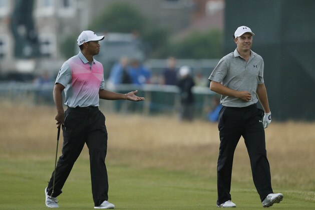 Tiger Woods of the US, left, walks along the 18th fairway with Jordan Spieth of the US during the third day of the British Open Golf championship at the Royal Liverpool golf club, Hoylake, England, Saturday July 19, 2014. (AP Photo/Alastair Grant)