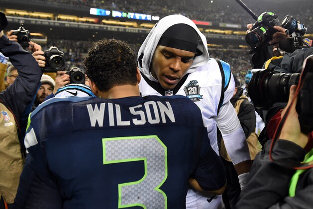 SEATTLE, WA - JANUARY 10:  Russell Wilson #3 of the Seattle Seahawks shakes hands with Cam Newton #1 of the Carolina Panthers after their 2015 NFC Divisional Playoff game at CenturyLink Field on January 10, 2015 in Seattle, Washington. The Seattle Seahawks defeated the Carolina Panthers 31 to 17.(Photo by Steve Dykes/Getty Images)