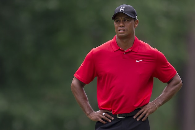 Tiger Woods pauses to consider his second shot on the fifth hole during the final round of the Wyndham Championship golf tournament at Sedgefield Country Club in Greensboro, N.C., Sunday, Aug. 23, 2015. (AP Photo/Rob Brown)