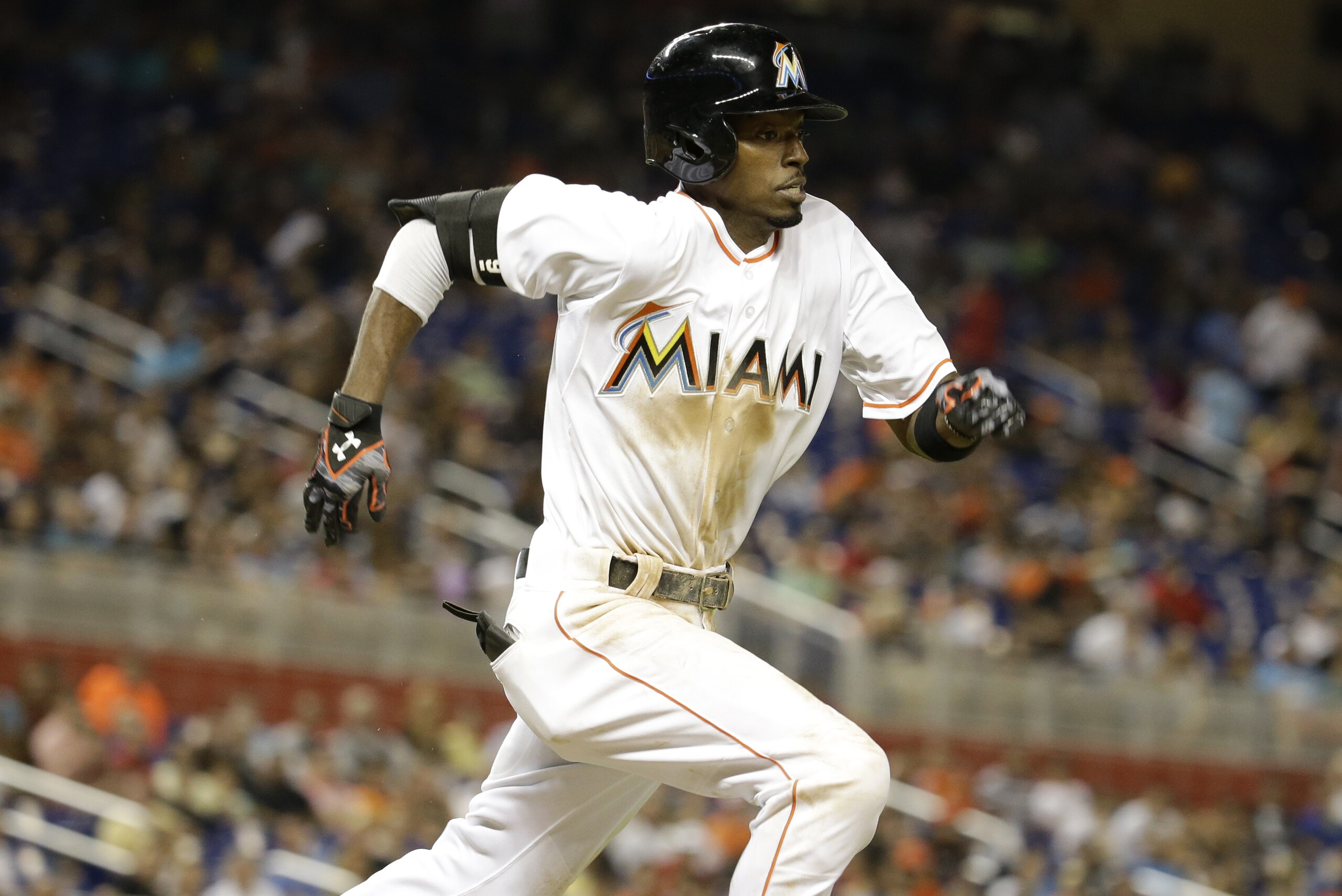Miami Marlins' Dee Gordon runs to first base during a  baseball game against the Atlanta Braves, Friday, Sept. 25, 2015, in Miami. The Dolphins defeated the Braves 12-11. (AP Photo/Lynne Sladky)