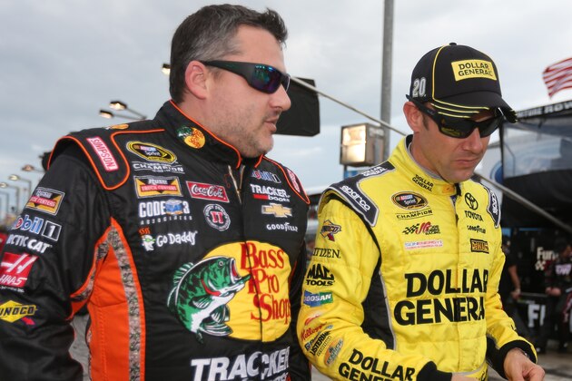 HOMESTEAD, FL - NOVEMBER 22:  Tony Stewart, driver of the #14 Bass Pro Shops/Mobil 1 Chevrolet, talks to Matt Kenseth, driver of the #20 Dollar General Toyota, during the NASCAR Sprint Cup Series Ford EcoBoost 400 at Homestead-Miami Speedway on November 22, 2015 in Homestead, Florida.  (Photo by Chris Graythen/Getty Images)