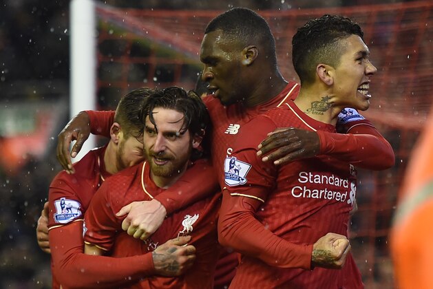 Liverpool's Welsh midfielder Joe Allen (2L) celebrates with teammates after scoring during the English Premier League football match between Liverpool and Arsenal at Anfield stadium in Liverpool, north-west England on January 13, 2016.
AFP PHOTO / PAUL ELLIS
RESTRICTED TO EDITORIAL USE. NO USE WITH UNAUTHORIZED AUDIO, VIDEO, DATA, FIXTURE LISTS, CLUB/LEAGUE LOGOS OR 'LIVE' SERVICES. ONLINE IN-MATCH USE LIMITED TO 75 IMAGES, NO VIDEO EMULATION. NO USE IN BETTING, GAMES OR SINGLE CLUB/LEAGUE/PLAYER PUBLICATIONS. / AFP / PAUL ELLIS        (Photo credit should read PAUL ELLIS/AFP/Getty Images)