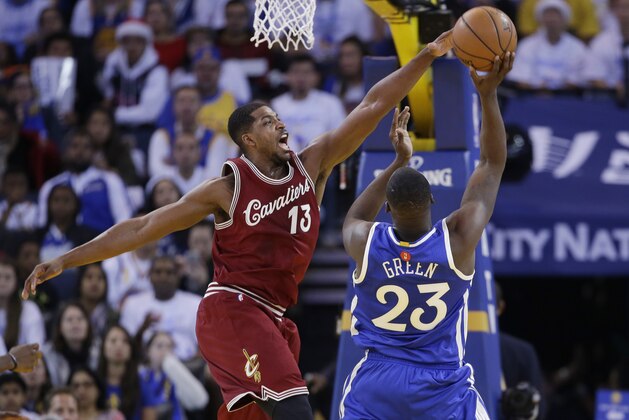 Cleveland Cavaliers' Tristan Thompson (13) in action against the Golden State Warriors' Draymond Green during an NBA basketball game Friday, Dec. 25, 2015, in Oakland, Calif. (AP Photo/Marcio Jose Sanchez)