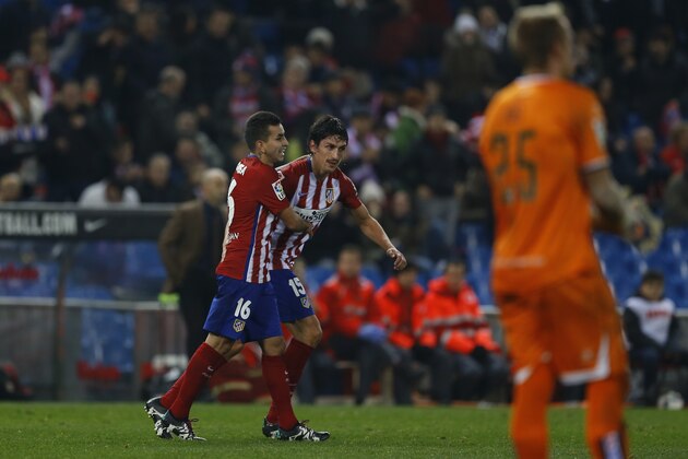 Atletico Madrid's Angel Correa, left, celebrates with teammate Stefan Savic after scoring the opening goal past Rayo Vallecano's goalkeeper Yoel, right, during the Copa del Rey second leg soccer match between Atletico Madrid and Rayo Vallecano at the Vicente Calderon stadium, in madrid, Thursday, Jan. 14, 2016. (AP Photo/Francisco Seco)