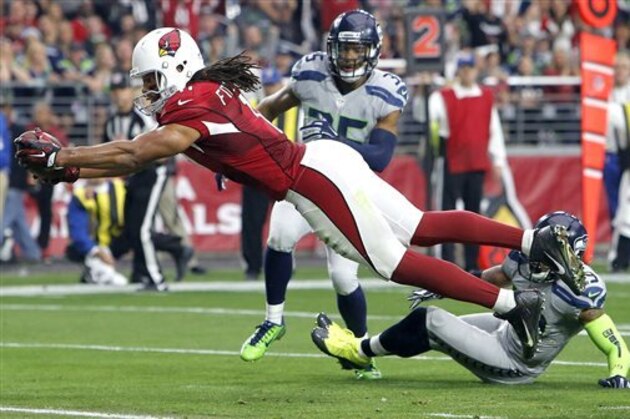Arizona Cardinals wide receiver Larry Fitzgerald (11) scores a touchdown against the Seattle Seahawks during the first half of an NFL football game, Sunday, Jan. 3, 2016, in Glendale, Ariz. (AP Photo/Rick Scuteri)