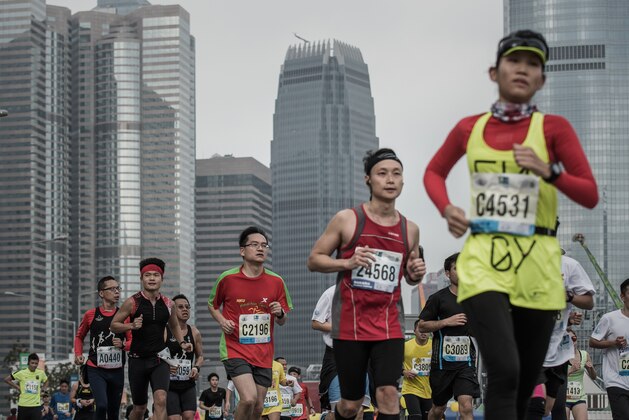 Runners take part in the Hong Kong Marathon on January 25, 2015.  About 73,000 people were expected to take to the streets for the Hong Kong Marathon.  AFP PHOTO / Philippe Lopez        (Photo credit should read PHILIPPE LOPEZ/AFP/Getty Images)
