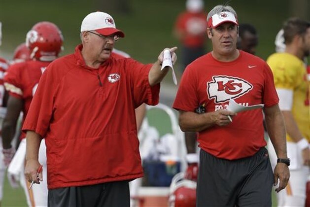 FILE - In this Aug. 17, 2015 file photo, Kansas City Chiefs head coach Andy Reid, left, and offensive coordinator Doug Pederson, right, talk during NFL football training camp in St. Joseph, Mo. Reid mentioned it almost as an aside, but it was a fairly significant fact: He has ceded some of the playcalling duties to Pederson, and the result has been a more dynamic offense. (AP Photo/Orlin Wagner, File)