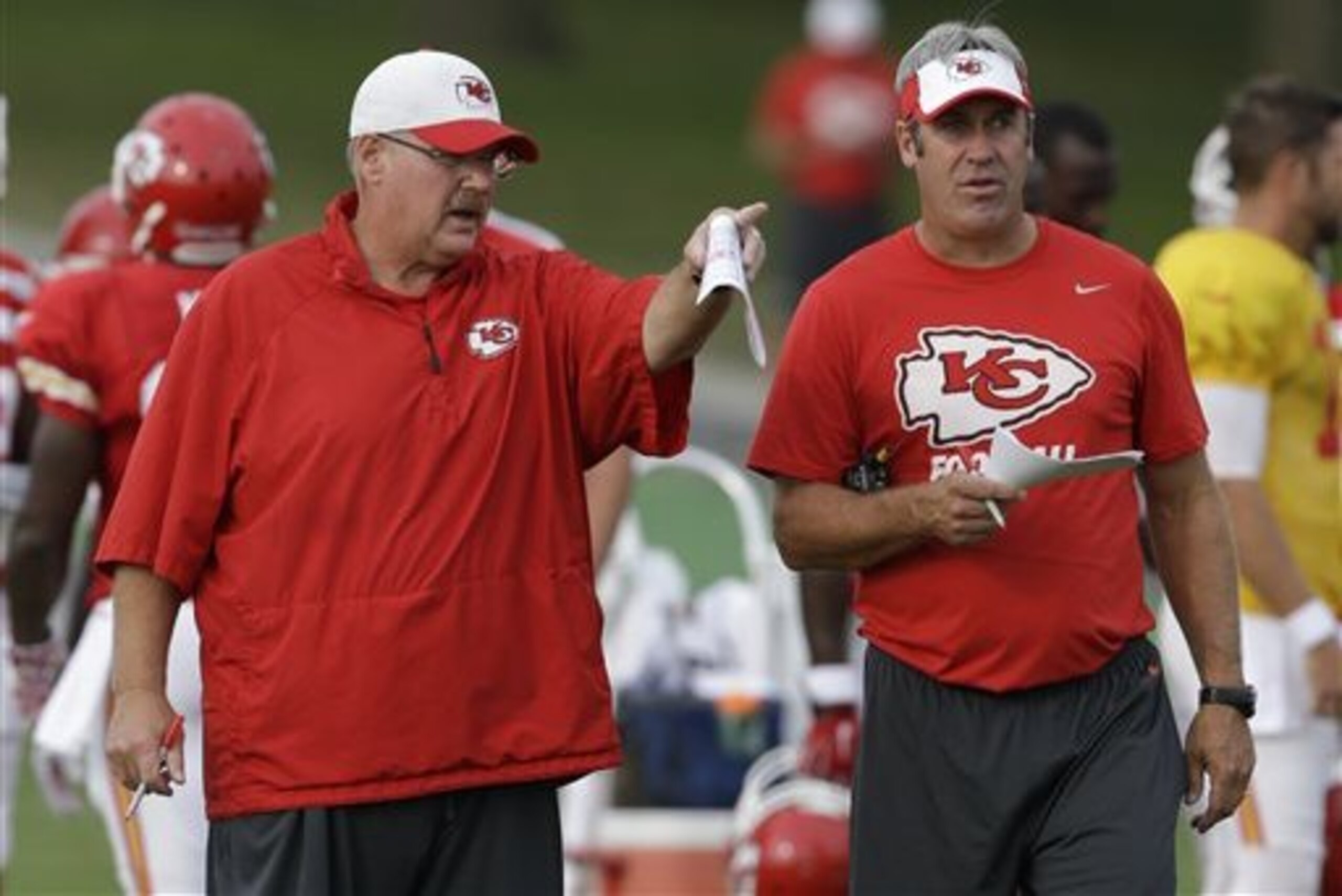 FILE - In this Aug. 17, 2015 file photo, Kansas City Chiefs head coach Andy Reid, left, and offensive coordinator Doug Pederson, right, talk during NFL football training camp in St. Joseph, Mo. Reid mentioned it almost as an aside, but it was a fairly significant fact: He has ceded some of the playcalling duties to Pederson, and the result has been a more dynamic offense. (AP Photo/Orlin Wagner, File)