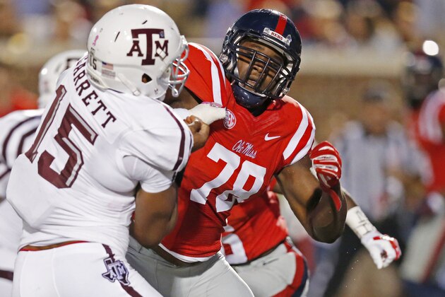 FILE - In this Oct. 24, 2015, file photo, Texas A&M defensive lineman Myles Garrett (15) is locked up by Mississippi offensive lineman Laremy Tunsil (78) during the first half of their NCAA college football game in Oxford, Miss. Some of the Southeastern Conference’s best players this season are Vadal Alexander, Ryan Kelly and Laremy Tunsil. If one or more of those names doesn’t ring a bell, that’s not surprising. They are part of an obscure group to most fans, but well-known to teammates, opponents and coaches.The three critical players are offensive linemen _ college football’s anonymous units that clear the way for more well-known players. (AP Photo/Rogelio V. Solis, File)