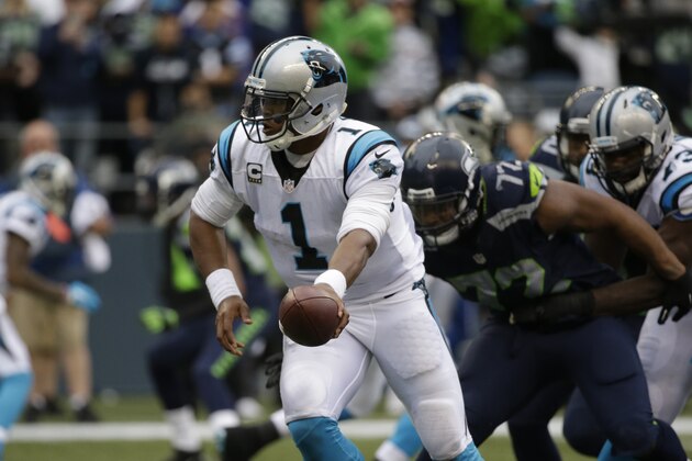 Carolina Panthers quarterback Cam Newton (1) hands off the football, in the second half of an NFL football game against the Seattle Seahawks, Sunday, Oct. 18, 2015, in Seattle. (AP Photo/Elaine Thompson)