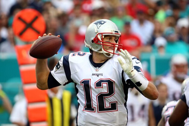 Jan 3, 2016; Miami Gardens, FL, USA; New England Patriots quarterback Tom Brady (12) scrambles during the second half against the Miami Dolphins at Sun Life Stadium. The Dolphins won 20-10. Mandatory Credit: Steve Mitchell-USA TODAY Sports