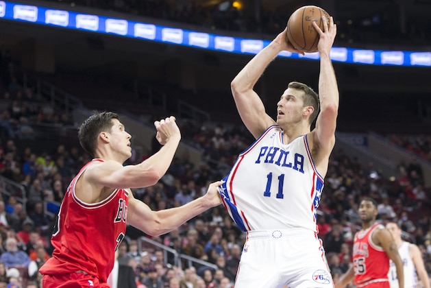 PHILADELPHIA, PA - JANUARY 14: Nik Stauskas #11 of the Philadelphia 76ers takes a shot over Doug McDermott #3 of the Chicago Bulls on January 14, 2016 at the Wells Fargo Center in Philadelphia, Pennsylvania. The Bulls defeated the 76ers 115-111. NOTE TO USER: User expressly acknowledges and agrees that, by downloading and or using this photograph, User is consenting to the terms and conditions of the Getty Images License Agreement. (Photo by Mitchell Leff/Getty Images)