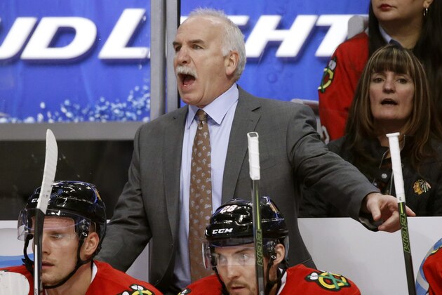 Chicago Blackhawks coach Joel Quenneville shouts to his players during the first period of an NHL hockey game against the Nashville Predators on Tuesday, Jan. 12, 2016, in Chicago. The Blackhawks have rewarded the three-time Stanley Cup-winning coach with a three-year contract extension which runs through 2019-20. (AP Photo/Charles Rex Arbogast)