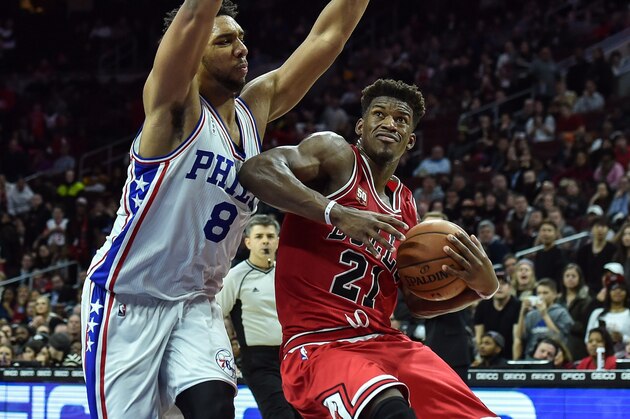 Jan 14, 2016; Philadelphia, PA, USA; Chicago Bulls guard Jimmy Butler (21) drives to the net as Philadelphia 76ers center Jahlil Okafor (8) defends during the fourth quarter of the game at the Wells Fargo Center. The Chicago Bulls won the game 115-111 in overtime. Mandatory Credit: John Geliebter-USA TODAY Sports