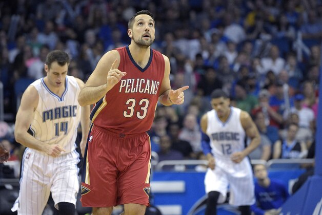 New Orleans Pelicans forward Ryan Anderson (33) reacts after scoring a three-point basket in front of Orlando Magic forward Jason Smith (14) and forward Tobias Harris (12) during the first half of an NBA basketball game in Orlando, Fla., Monday, Dec. 28, 2015. (AP Photo/Phelan M. Ebenhack)