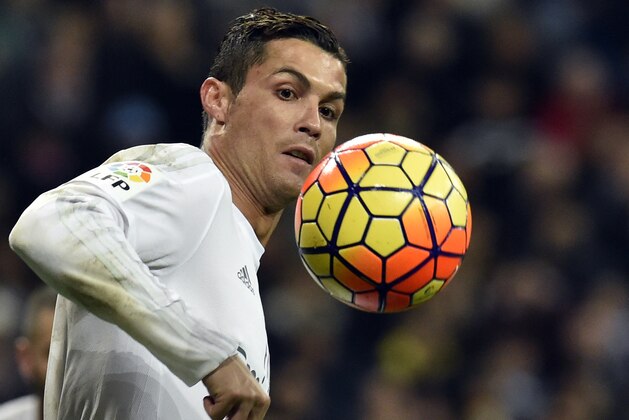 Real Madrid's Portuguese forward Cristiano Ronaldo looks at the ball during the Spanish league football match Real Madrid CF vs RC Deportivo La Coruna at the Santiago Bernabeu stadium in Madrid on January 9, 2016.  AFP PHOTO / GERARD JULIEN / AFP / GERARD JULIEN        (Photo credit should read GERARD JULIEN/AFP/Getty Images)